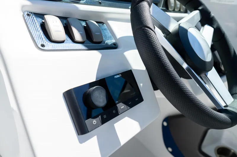 Slide: The Image of 2023 Hurricane SunDeck 2690 OB steering wheel and control panel close-up. - 19