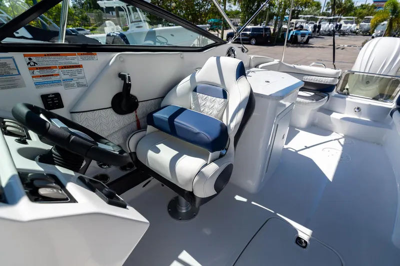 Slide: The Image of 2023 Hurricane SunDeck 2690 OB boat interior with steering wheel and seating. - 21