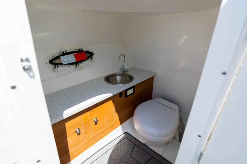 Slide: The Image of 2023 Hurricane SunDeck 2690 OB boat interior with sink and toilet. - 26