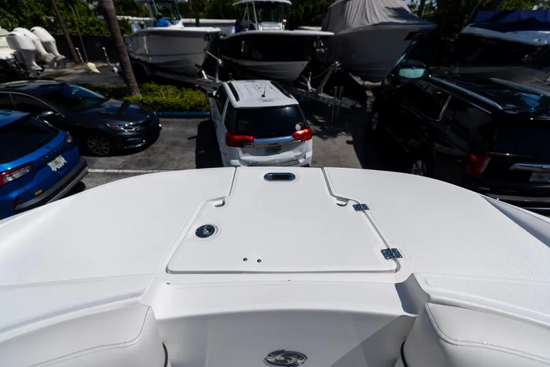 Slide: The Image of 2023 Hurricane SunDeck 2690 OB boat in parking lot, surrounded by cars and other boats. - 34