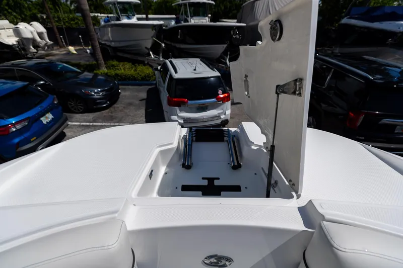 Slide: The Image of 2023 Hurricane SunDeck 2690 OB boat storage compartment open in parking lot. - 35
