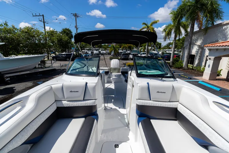 Slide: The Image of 2023 Hurricane SunDeck 2690 OB boat interior with seating, under sunny skies. - 36