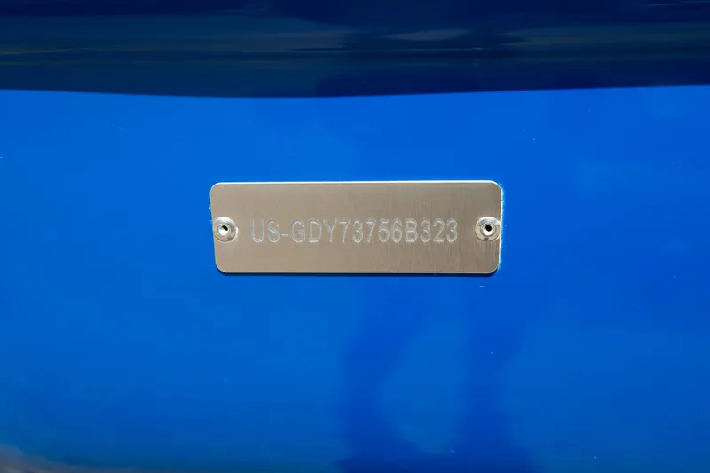 Slide: The Image of 2023 Hurricane SunDeck 2690 OB boat identification plate on blue hull. - 37