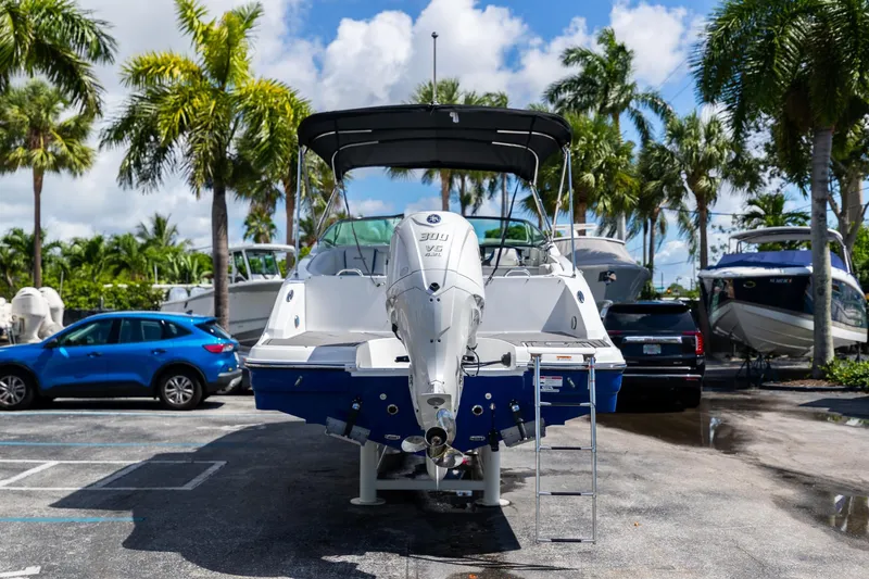 Slide: The Image of 2023 Hurricane SunDeck 2690 OB boat in a sunny marina setting. - 7