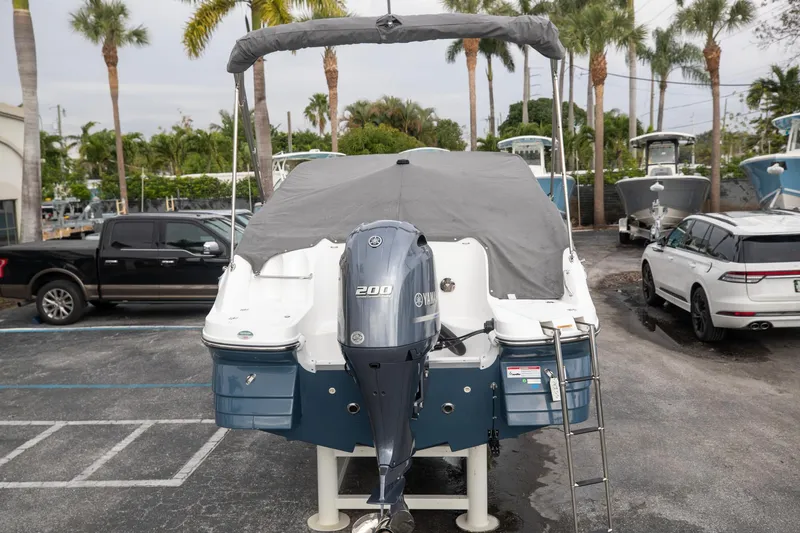 Slide: The Image of 2023 Hurricane SunDeck 2200 OB boat with Yamaha 200 engine, parked outdoors. - 11