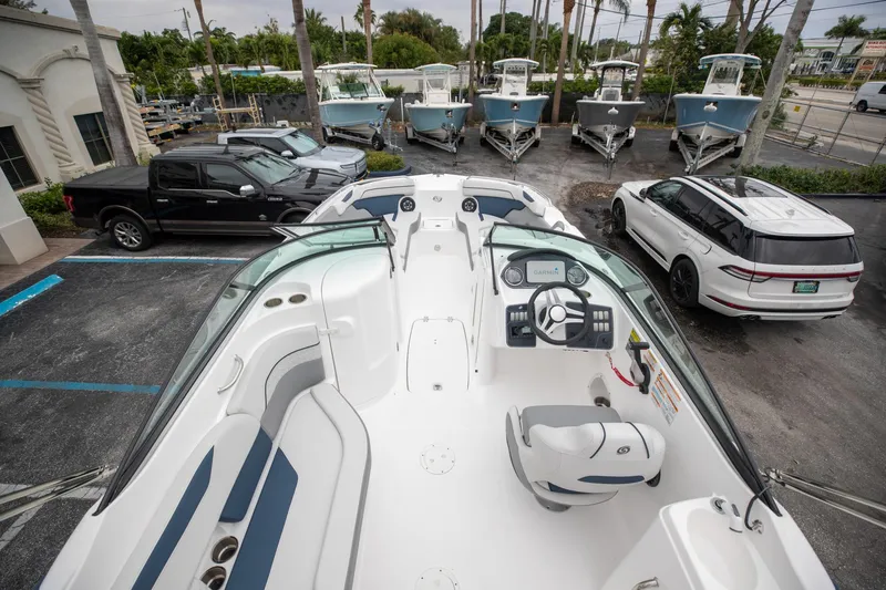 Slide: The Image of 2023 Hurricane SunDeck 2200 OB boat in parking lot with cars and other boats. - 15
