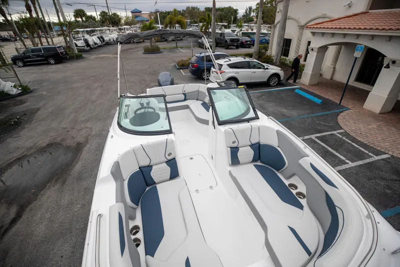 Slide: The Image of 2023 Hurricane SunDeck 2200 OB boat with spacious seating in a parking lot. - 32