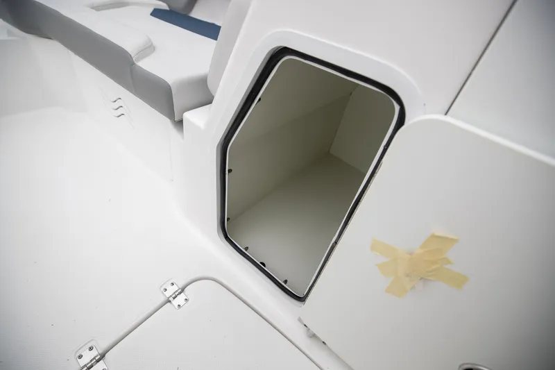 Slide: The Image of 2023 Hurricane SunDeck 2200 OB boat storage compartment with open door. - 36