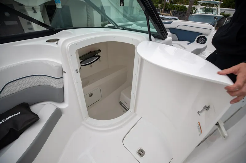 Slide: The Image of 2023 Hurricane SunDeck 2200 OB boat interior with open storage compartment. - 45