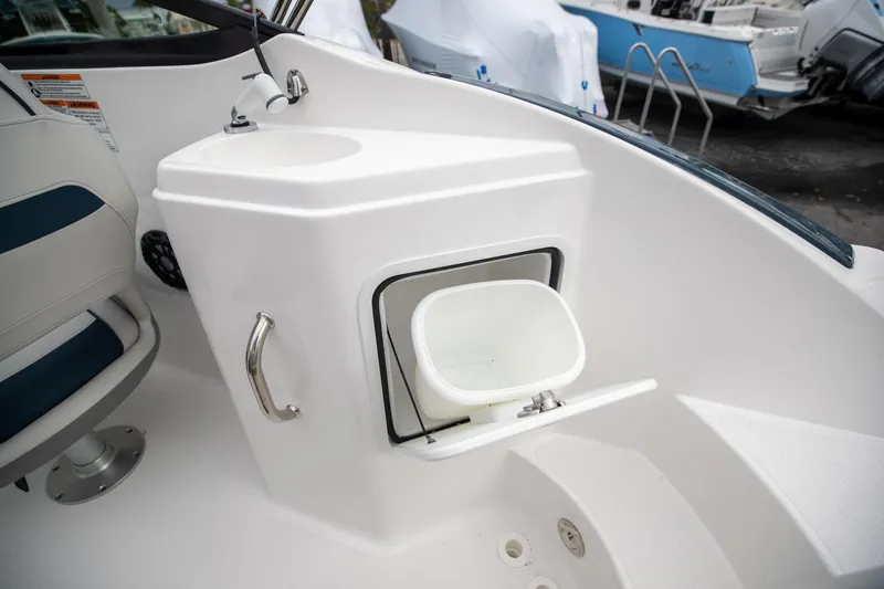 Slide: The Image of 2023 Hurricane SunDeck 2200 OB boat interior with sink and storage compartment. - 49