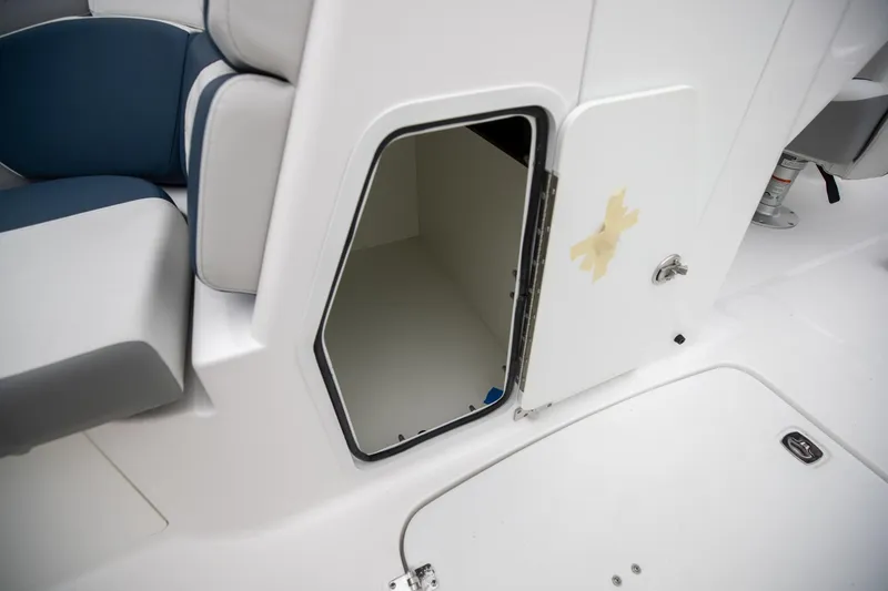 Slide: The Image of 2023 Hurricane SunDeck 2200 OB boat storage compartment with open door. - 24