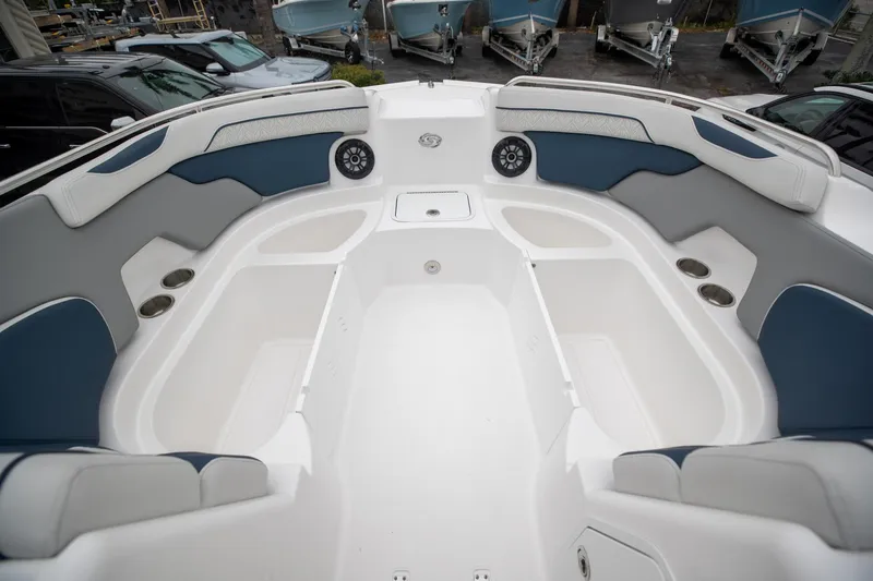 Slide: The Image of 2023 Hurricane SunDeck 2200 OB boat interior with spacious seating and cup holders. - 25