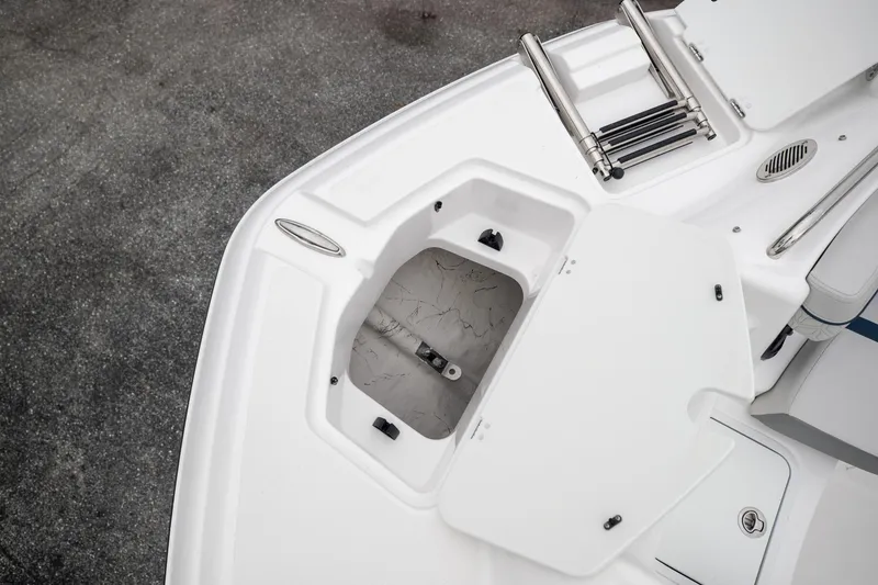 Slide: The Image of 2023 Hurricane SunDeck 2200 OB boat deck with storage compartment and ladder. - 28