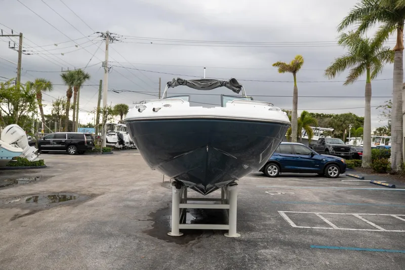 Slide: The Image of 2023 Hurricane SunDeck 2200 OB boat displayed on a stand in a parking lot. - 3
