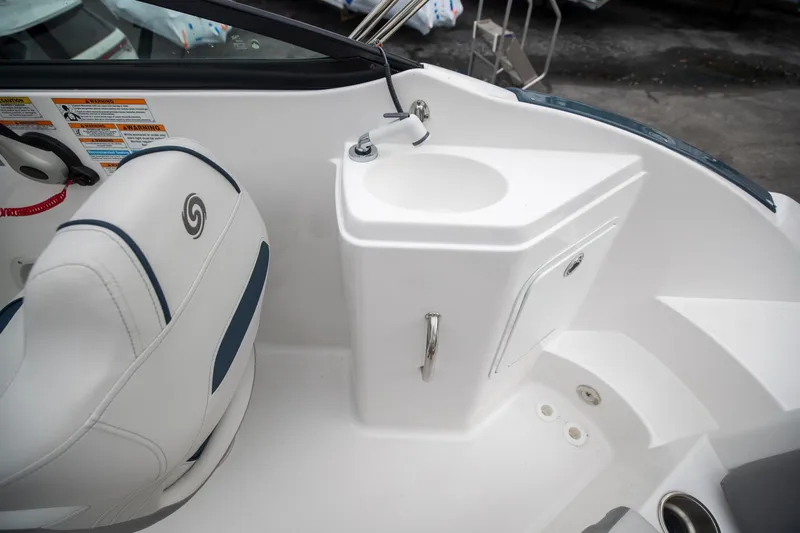 Slide: The Image of 2023 Hurricane SunDeck 2200 OB boat interior with seat and sink area. - 34