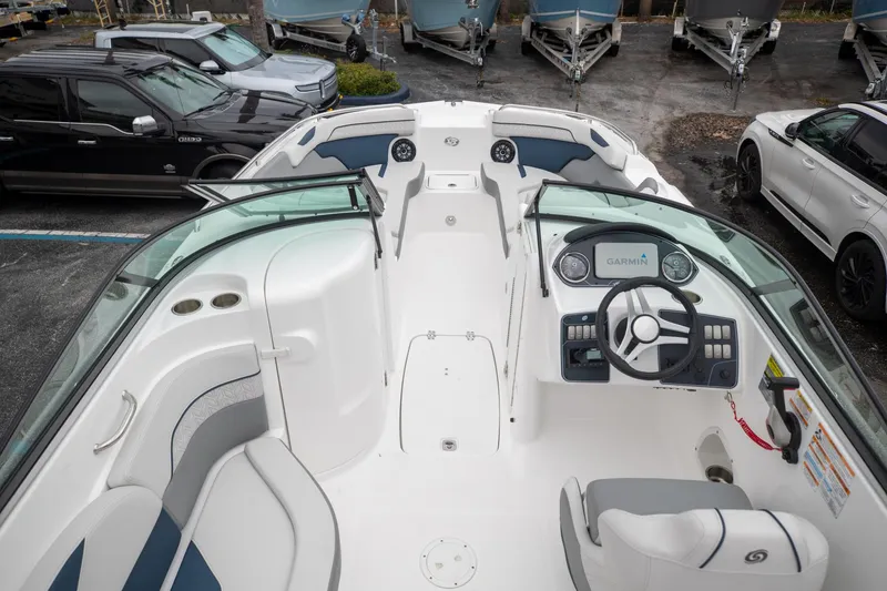 Slide: The Image of 2023 Hurricane SunDeck 2200 OB boat interior with steering wheel and seating. - 8