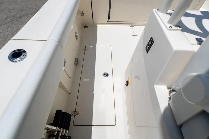 Slide: The Image of 2024 Cobia 320 CC boat interior, featuring sleek design and storage compartments. - 15