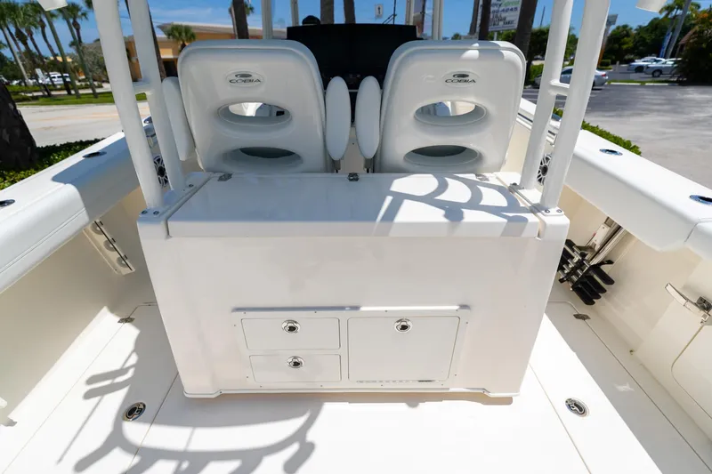 Slide: The Image of 2024 Cobia 320 CC boat interior with seating and storage compartments. - 17