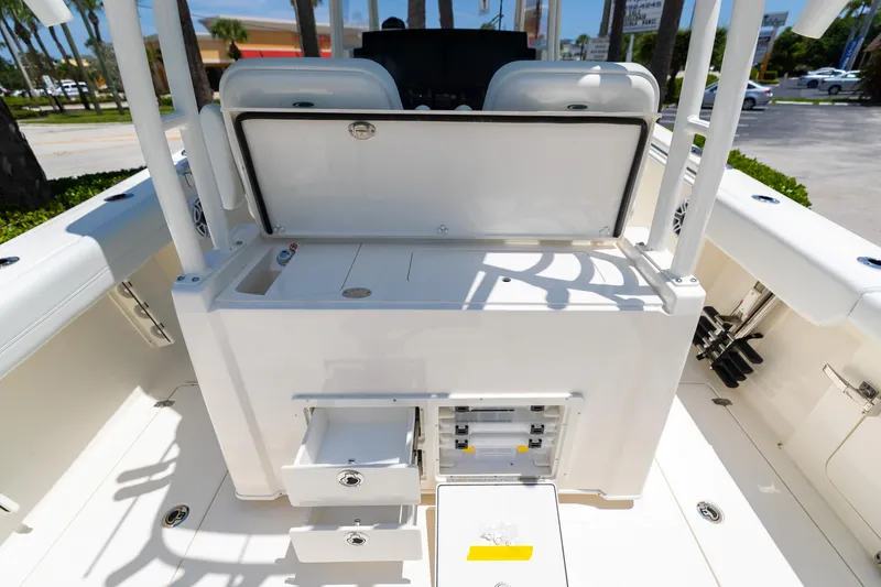 Slide: The Image of 2024 Cobia 320 CC boat interior with storage compartments and seating. - 18