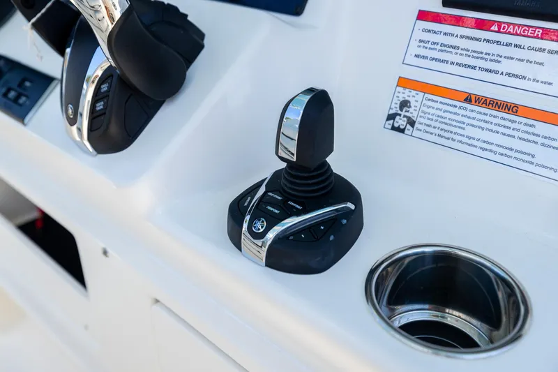 Slide: The Image of Control panel of 2024 Cobia 320 CC boat with joystick and warning labels. - 21