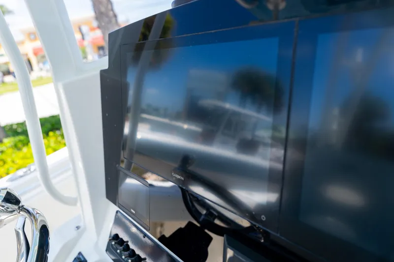 Slide: The Image of Close-up of 2024 Cobia 320 CC boat's Garmin display and controls. - 25
