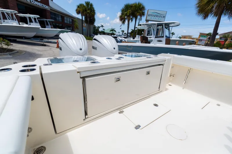 Slide: The Image of 2024 Cobia 320 CC boat interior with Yamaha engines at marina. - 8