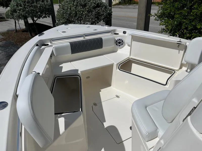 Slide: The Image of 2024 Cobia 240 CC boat interior with seating and storage compartments. - 14