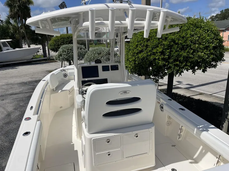 Slide: The Image of 2024 Cobia 240 CC boat interior with helm, seating, and storage compartments. - 10