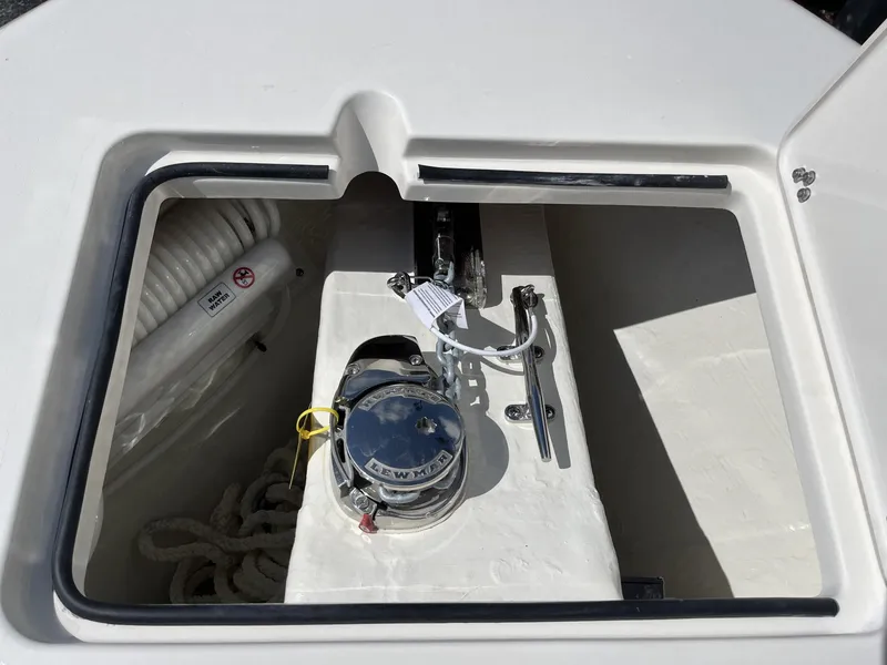 Slide: The Image of Anchor compartment of 2024 Cobia 240 CC boat with winch and rope storage. - 16