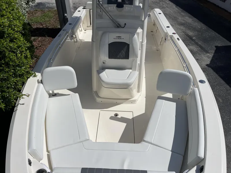 Slide: The Image of 2024 Cobia 240 CC boat interior with white seating and console. - 17
