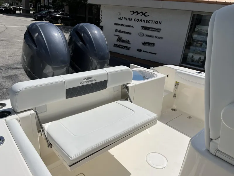 Slide: The Image of 2024 Cobia 240 CC boat interior with dual engines and seating at Marine Connection. - 24