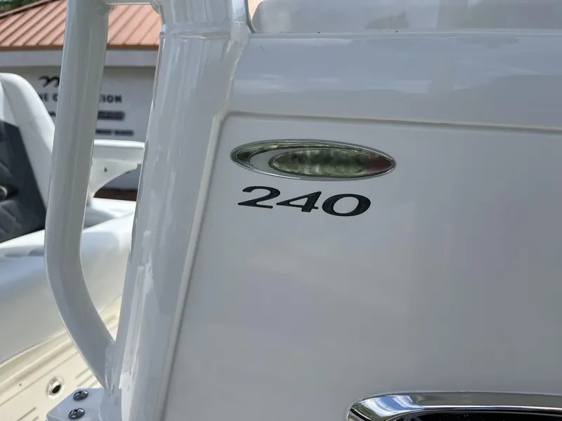 Slide: The Image of 2024 Cobia 240 CC boat detail with model number on white surface. - 19