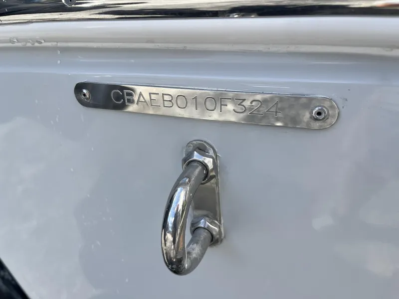 Slide: The Image of 2024 Cobia 240 CC boat hull identification number plate and cleat. - 7