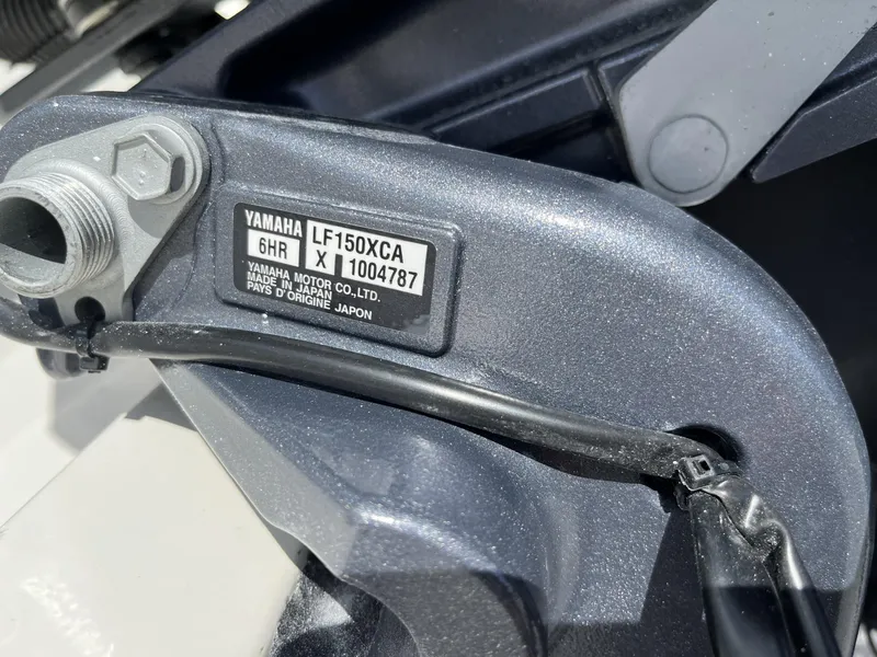 Slide: The Image of Close-up of Yamaha LF150XCA engine part on 2024 Cobia 240 CC boat. - 8