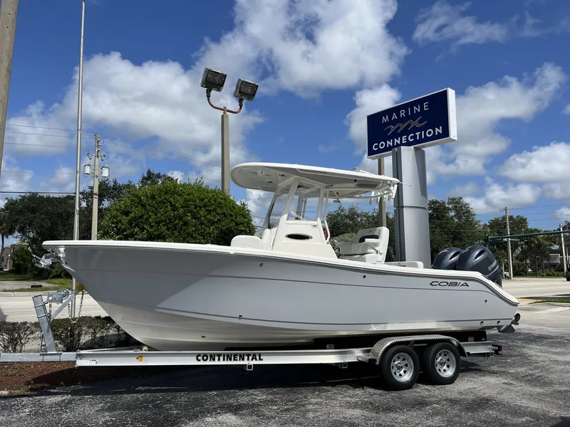 Slide: The Image of 2024 Cobia 240 CC boat on trailer at Marine Connection dealership. - 1