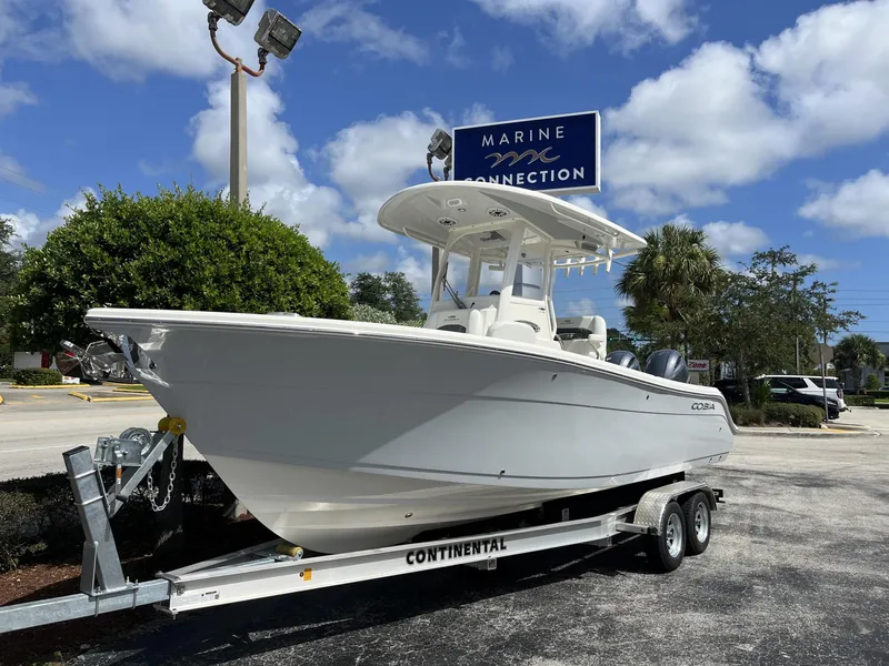 Slide: The Image of 2024 Cobia 240 CC boat on trailer at Marine Connection dealership. - 2