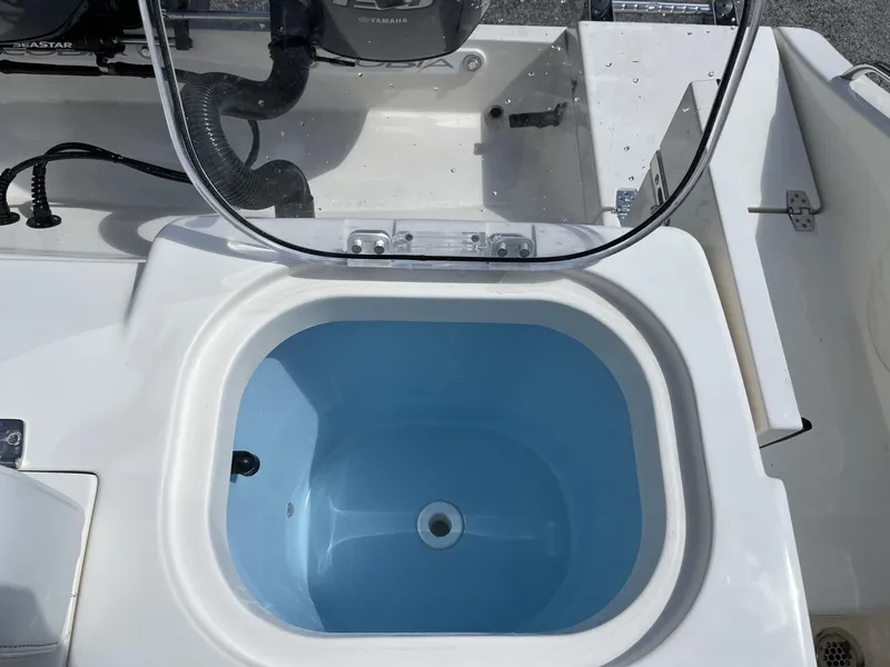 Slide: The Image of Livewell on 2024 Cobia 240 CC boat, featuring a clean, blue interior. - 22