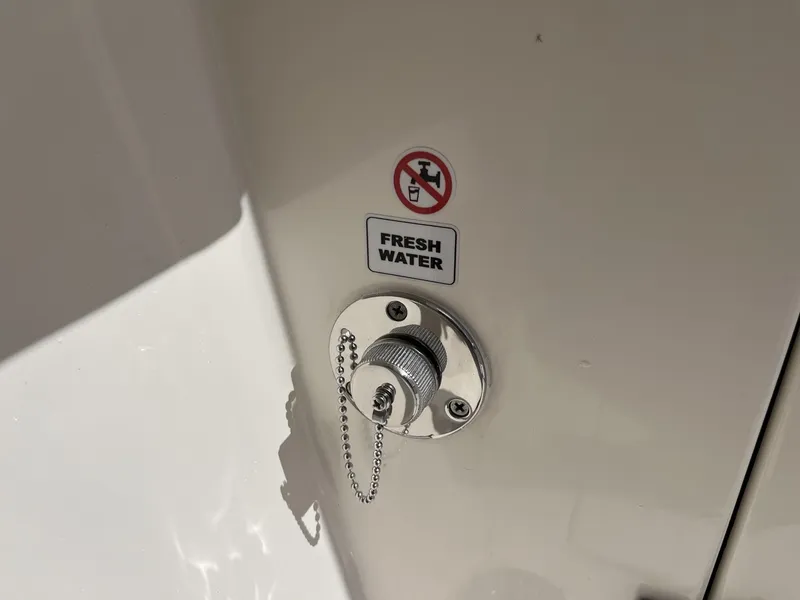 Slide: The Image of Fresh water inlet on 2024 Cobia 240 CC boat with no drinking symbol. - 25