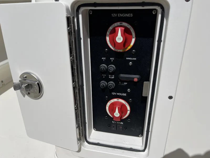 Slide: The Image of Control panel of 2024 Cobia 240 CC boat, featuring 12V engine and house switches. - 29