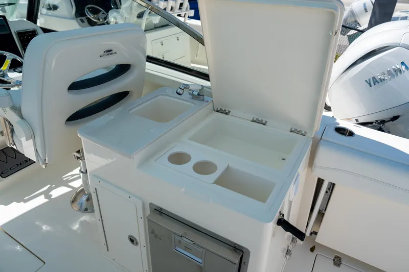 Slide: The Image of 2024 Cobia 280 DC boat interior with sink and storage area. - 19