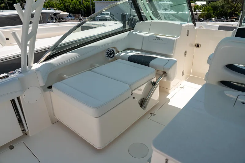 Slide: The Image of 2024 Cobia 280 DC boat interior with white seating and modern design. - 25