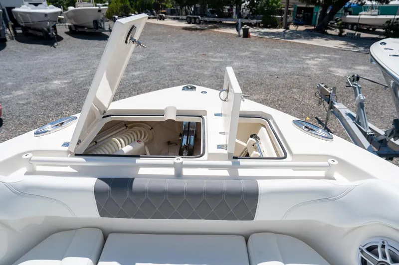 Slide: The Image of 2024 Cobia 280 DC boat storage compartments open, showcasing interior features. - 33
