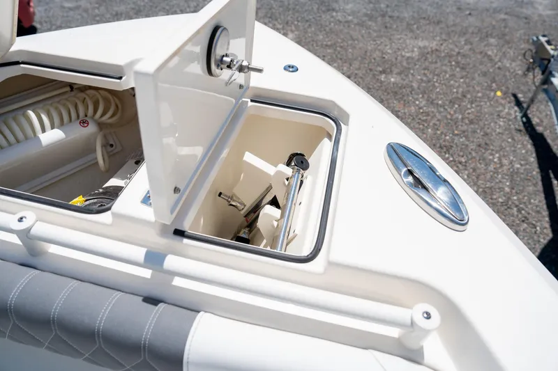 Slide: The Image of Open storage compartment on 2024 Cobia 280 DC boat, showcasing interior details. - 35