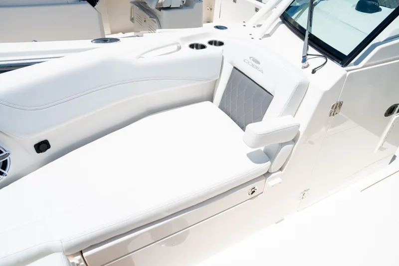Slide: The Image of 2024 Cobia 280 DC boat interior with white seating and cup holders. - 39