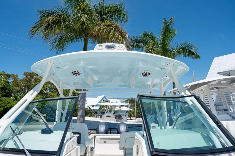 Slide: The Image of 2024 Cobia 280 DC boat with palm trees in the background. - 40