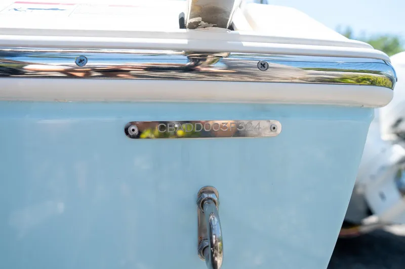 Slide: The Image of 2024 Cobia 280 DC boat with identification plate and chrome details. - 43