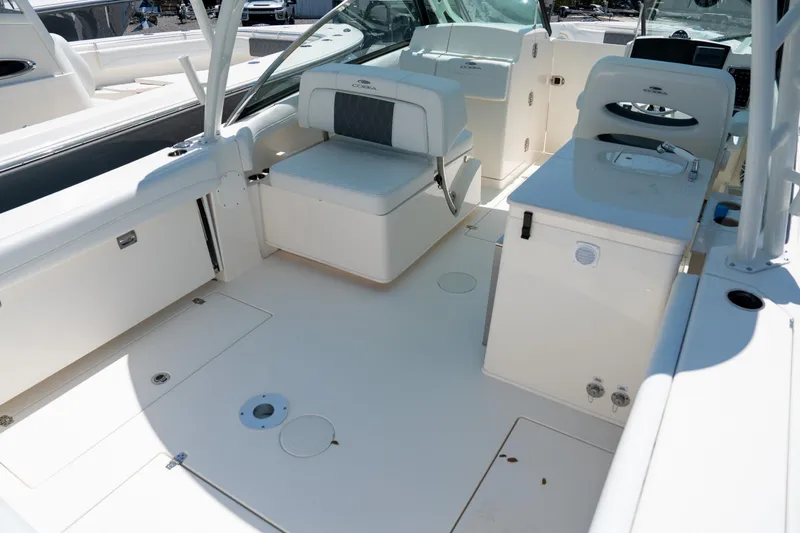 Slide: The Image of 2024 Cobia 280 DC boat interior with seating and storage compartments. - 9