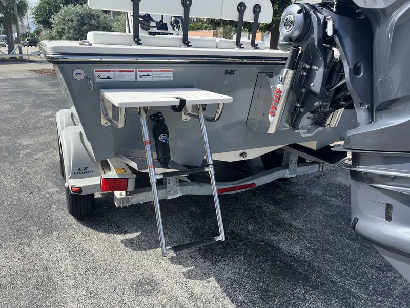 Slide: The Image of 2024 Hewes Redfisher 21 boat rear view with motor and trailer. - 10