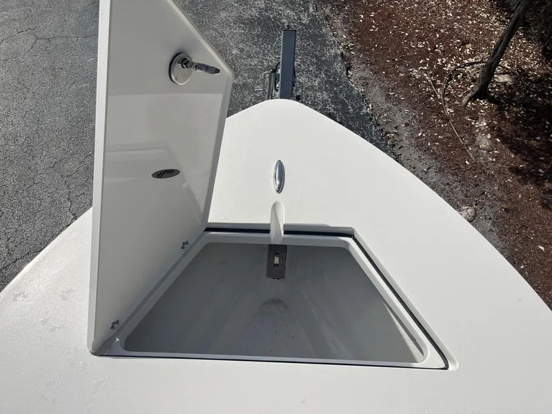 Slide: The Image of Open storage compartment on 2024 Hewes Redfisher 21 boat deck. - 14
