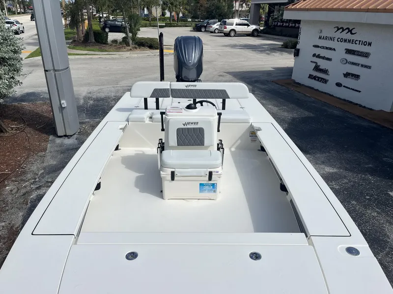 Slide: The Image of 2024 Hewes Redfisher 21 boat at Marine Connection dealership, showcasing seating and deck layout. - 15